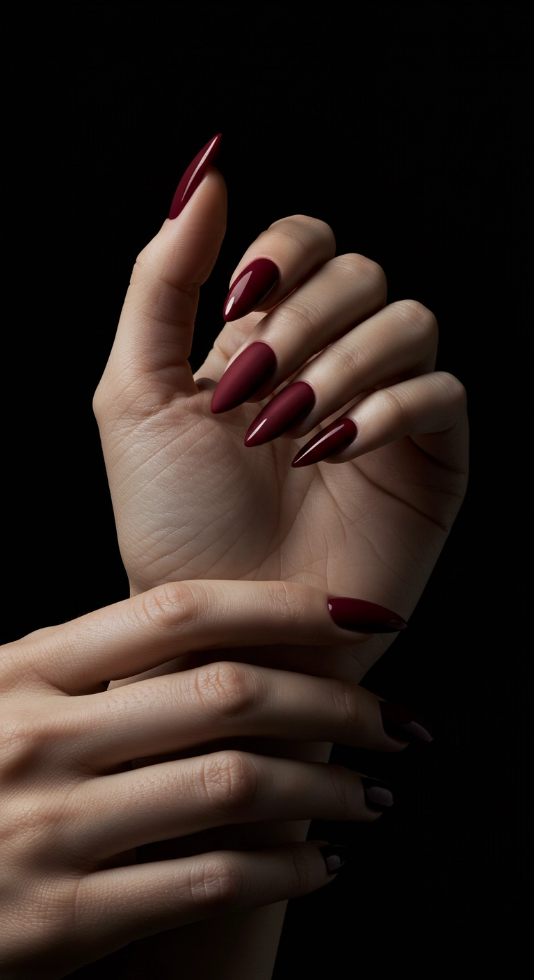 Stiletto nails in a matte red finish with a contrasting high-gloss tip.