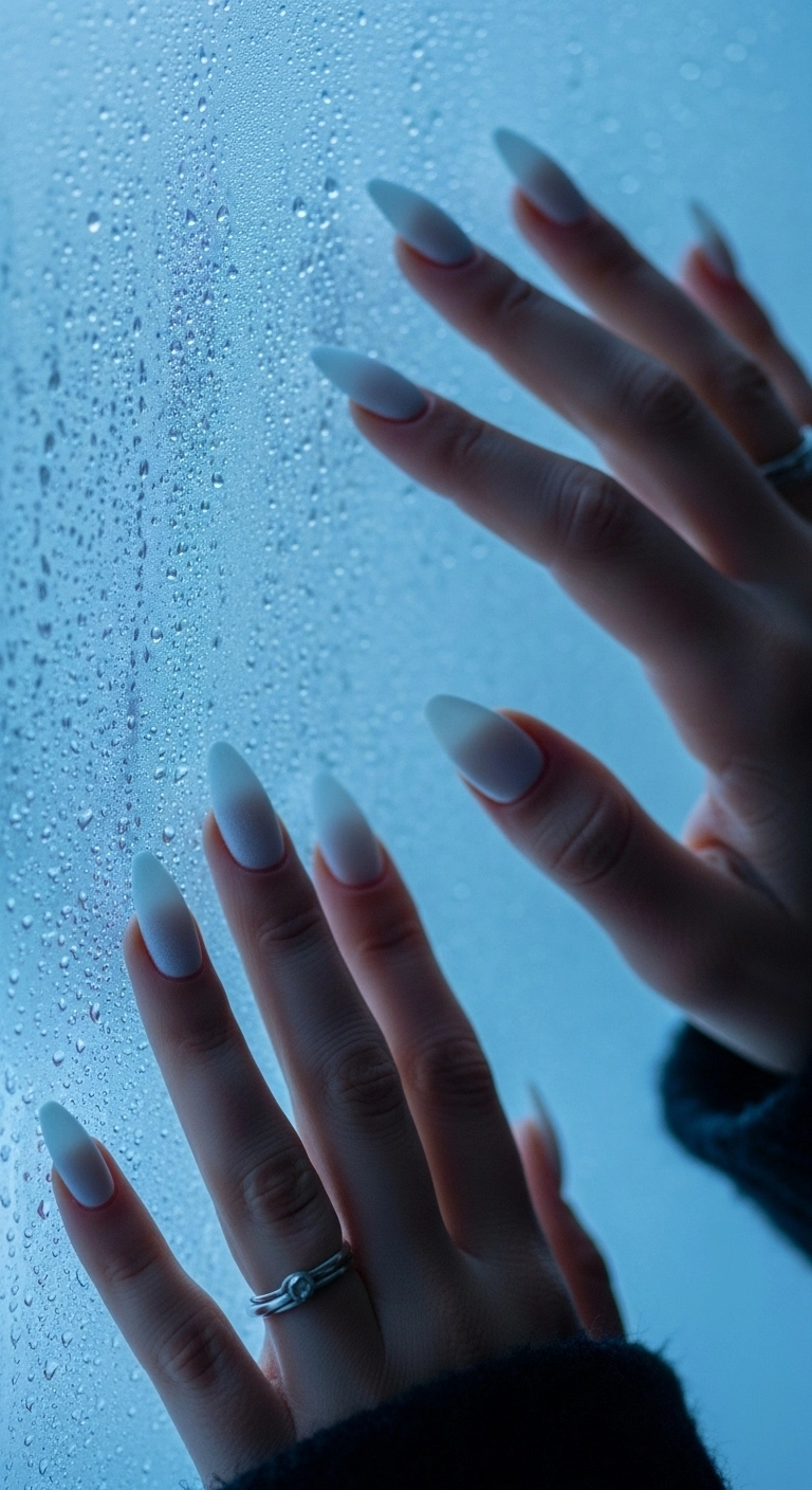 Long stiletto nails with a pure white matte polish that looks like frosted glass.