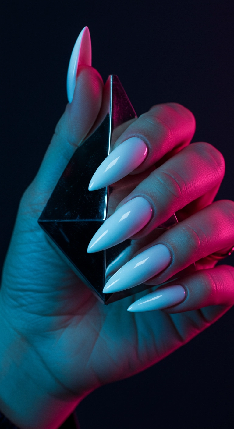 A woman's stiletto nails with a futuristic, high-shine white chrome finish.