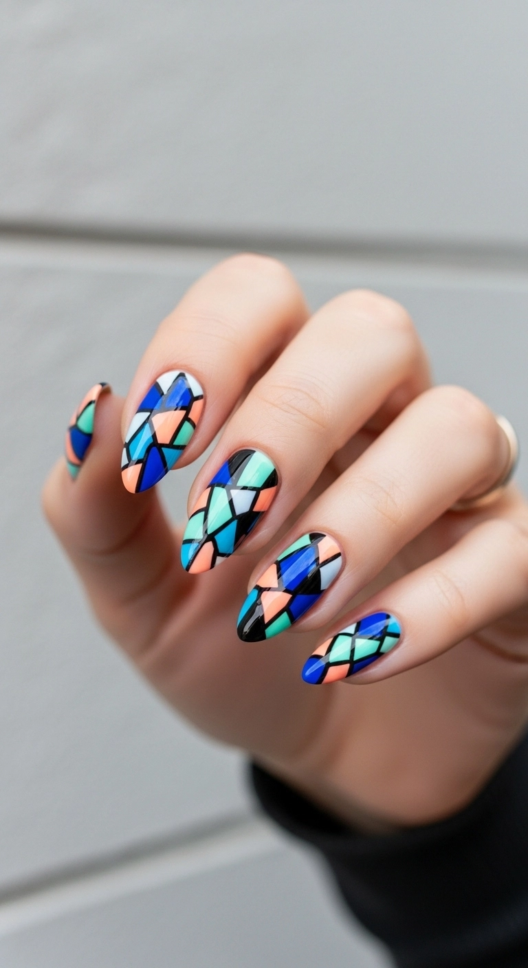 Almond nails with a multi-color geometric mosaic or stained glass design.