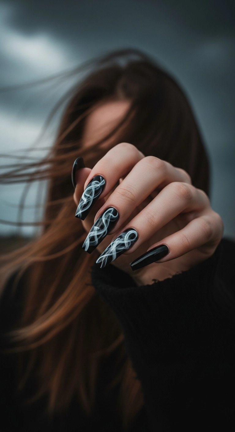 Woman's hand displaying long coffin nails with a realistic smoke effect over a black base.