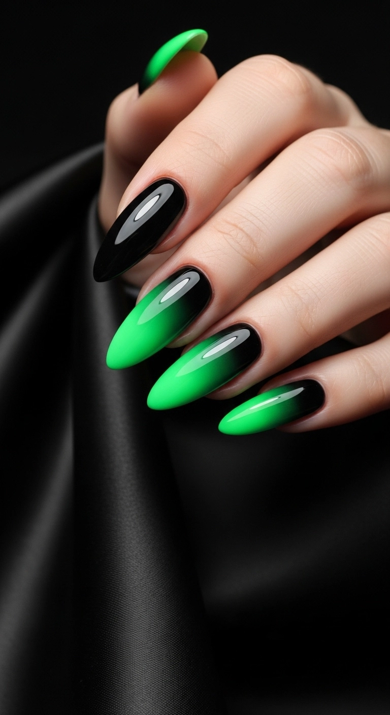 Long almond nails with a smooth black to neon green ombré gradient effect.
