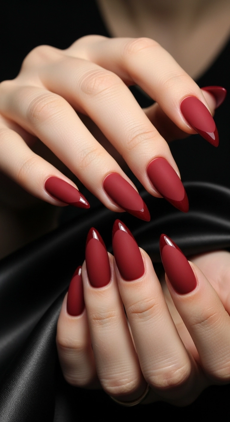 Elegant and modern Christmas nails featuring a matte red base with a high-gloss red tip.