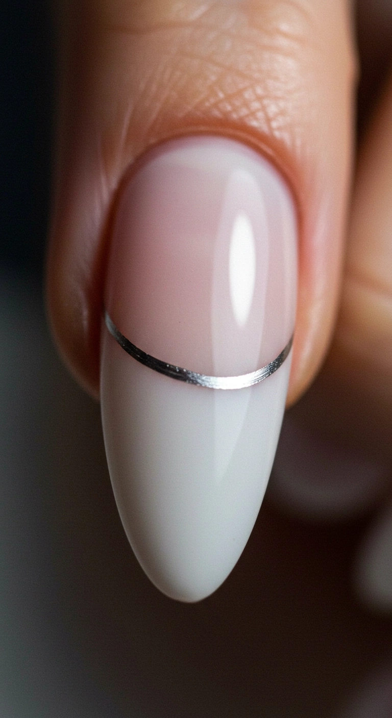 A macro shot of milky white nails with a very thin, precise silver line tracing the cuticle.