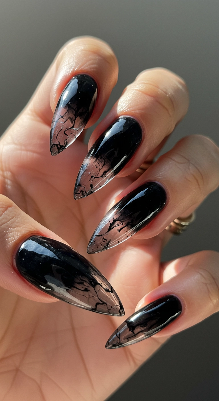 A close-up of a stiletto nail with a high-gloss, translucent, sheer 